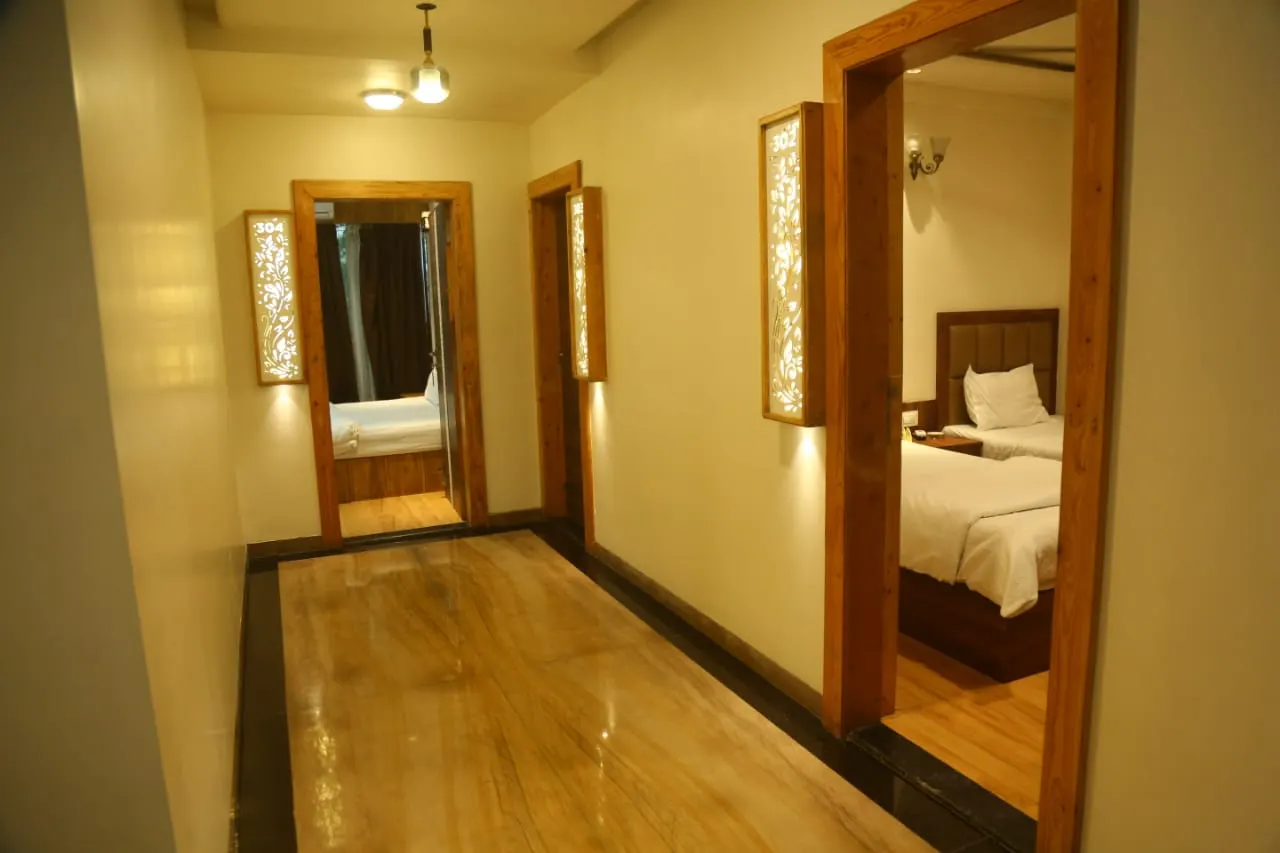 Corridor at Hotel Evershine with teak door frames and carved backlit panels